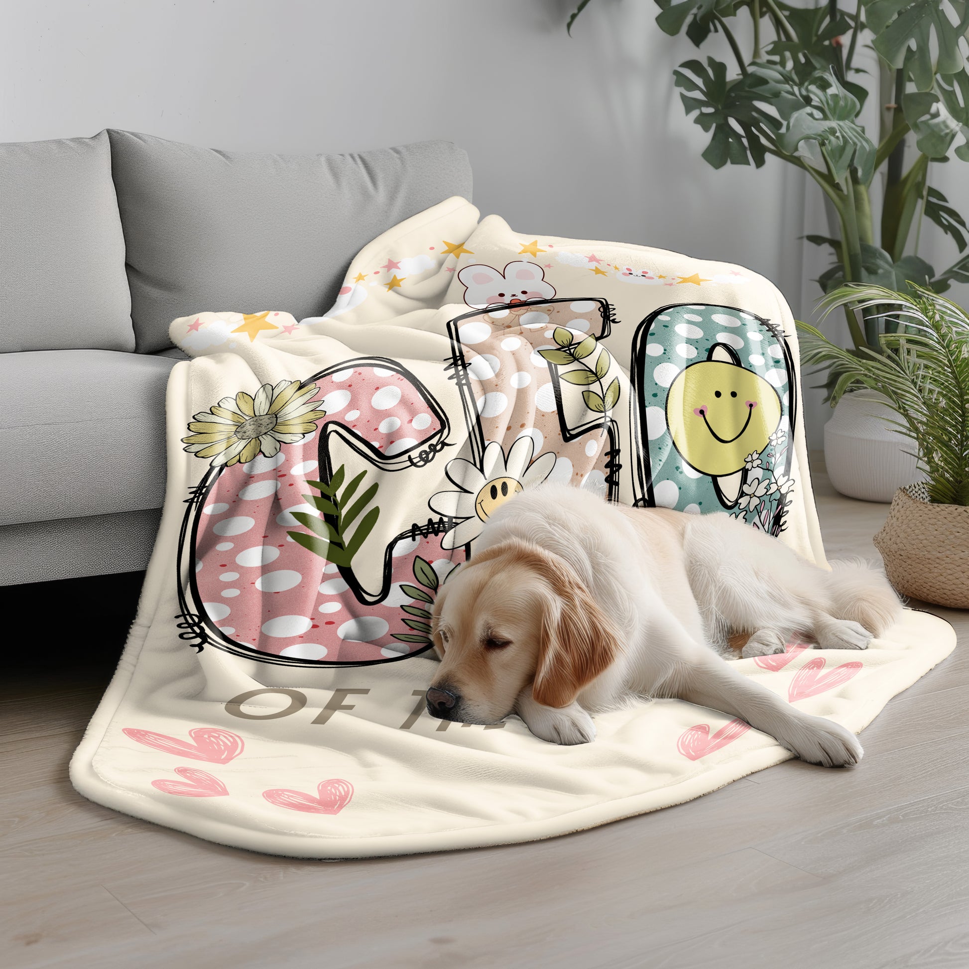 Cozy Sherpa fleece blanket with playful 'CEO of the House' design, adorned with colorful polka dots, flowers, and a smiling sun, draped on a light gray couch, with a golden retriever resting peacefully beside it