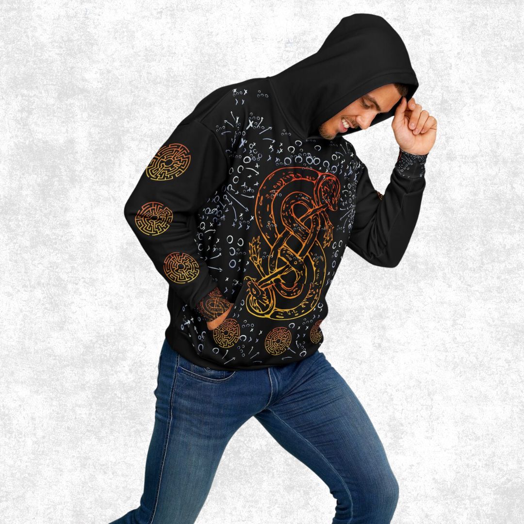 Man wearing a black all-over print hoodie with a vibrant orange and yellow serpent design, surrounded by Viking-inspired runes and intricate patterns.